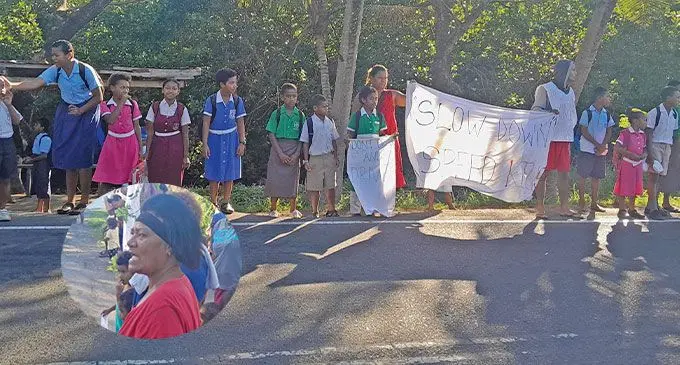 Parents from Aquilau, Narewa, Nadi, with their children raising road safety awareness along Denarau Rd.