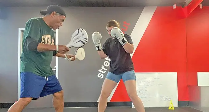 Trainer Lepani Wilson (left) works with boxer Mia in Sydney, Australia.