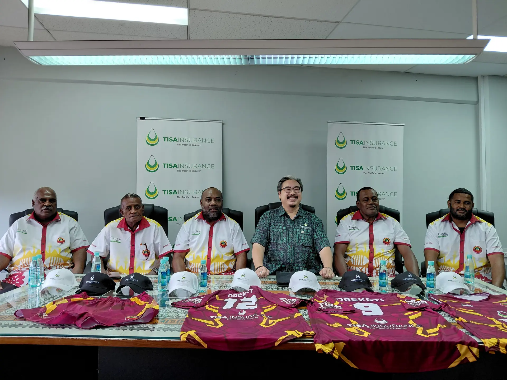 TISA Insurance (Fiji) Limited chief executive officer David Ariff Chan with representatives from the Dreketi Rugby Club during the handover of their jerseys.