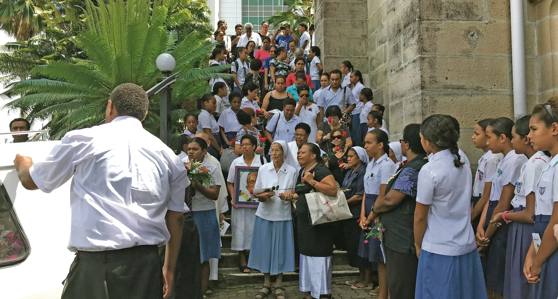 Family and friends watch pall-bearers carry the coffin of the late Sister Angela Cavey to the hearse in Suva on March 6, 2018. Photo: Ashna Kumar