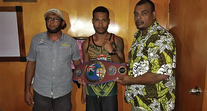 Boxing Commission of Fiji (West) director Usman Lale Ali, Rakuro Daunivavana and promoter Freddy Chande with the Fiji super welterweight title in Martintar, Nadi. Photo: Supplied by Freddy Chand