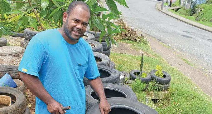 Joe Captain while re-using old tyres to make his fence and plant flowers at his Leys Road home in Raiwai, Suva, on February 26, 2019. Photo: Ronald Kumar
