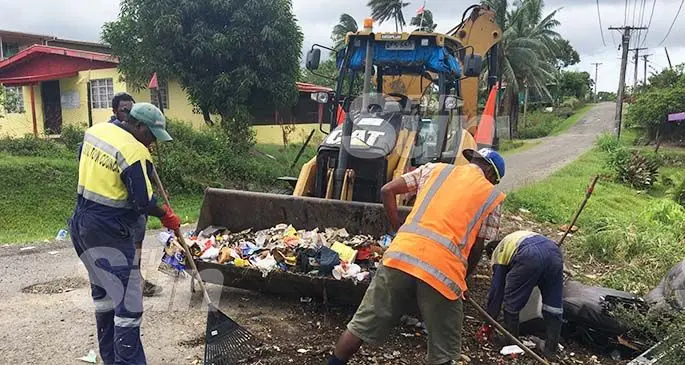 Nasinu Town Council workers clearing away rubbish that was piled along the roadside. Photo: Renu Radhika