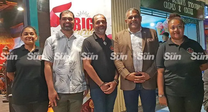 Second from left: Grills Restaurant and Bar owners and brothers, Vimal and Divesh Kumar and Minister for Commerce, Trade and Tourism, Faiyaz Koya, with restaurant employees during the opening on April 13, 2022. Photo: Nicolette Chambers