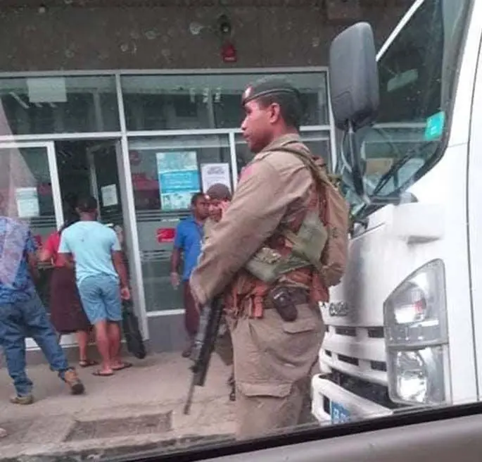 A Republic of the Fiji Military Forces soldier stands guard outside the Fiji National Provident Fund Lautoka branch on March 30, 2020.