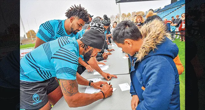 Flying Fijians captain Waisea Nayacalevu and Isoa Nasilasila sign autographs for their fans in Lille, France, on November 15, 2022. Photo: Supplied