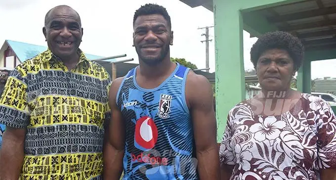Paramatta Eels winger Maikeli Sivo is flanked by his dad Joeli Nawalu and mum Mere Nawalu during their Christmas celebration in Momi, Nadroga yesterday. Photo: Waisea Nasokia 