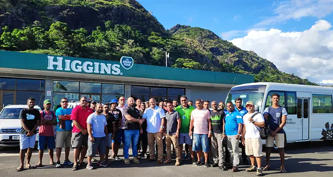 Centre: Eroni Puamau, General Manager Rosie Holidays shaking hands with Peter Brown, Head of Operations for Higgins Fiji Limited, flanked by some of the former Rosie employees.. Photo: Rosie Holidays.