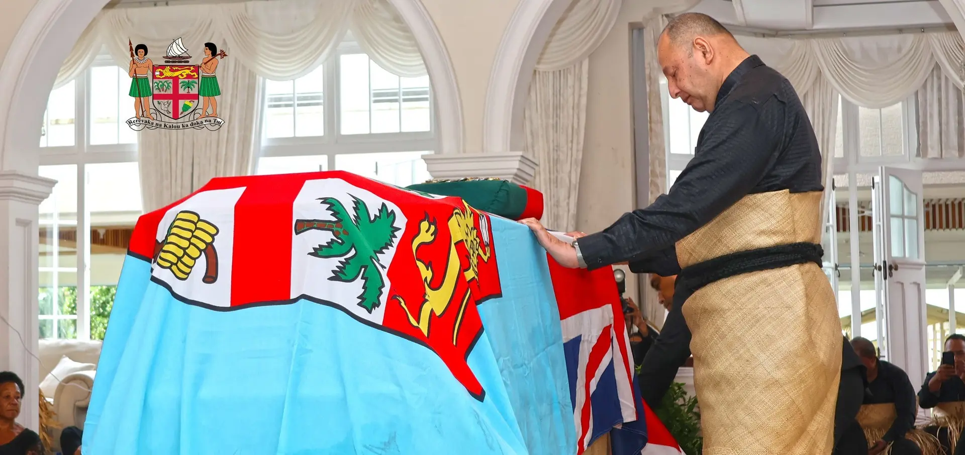 The Tongan monarch, accompanied by members of his family, stood in silence before the casket during a brief but solemn visit.
