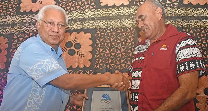 Oceania National Olympic Committees president Dr Robin Mitchell (left) hands the award to Joe Rodan Snr who received it on behalf of his son Joe Rodan Jnr during the Fiji Sports Hall of Fame and Fiji Olympic Order at the South Sea Orchids, Nadi on March 15, 2019. Photo: Nicolette Chambers
