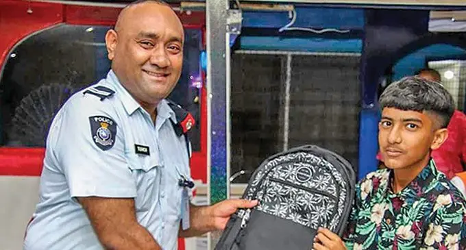 A Police officer hands over some of the school equipment to a student. Photo: Police Media Cell Participants at the handover ceremony of the school equipment from the Ramcharitmanas Global Fiji, Tuirara Kams Feeder Road Crime Prevention Committee (CPC), and Tuirara Community Post personnel to students. Photo: Police Media Cell Deputy Commissioner of Police Itendra Nair presents a going away present to New Zealand Police