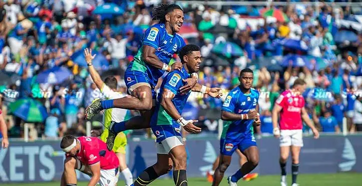 Swire Shipping Fijian Drua backs (from left) Selestino Ravutaumada congratulates Ilaisa Droasese after scoring the first try against Melbourne Rebels on April 1, 2023. Photo: Leon Lord