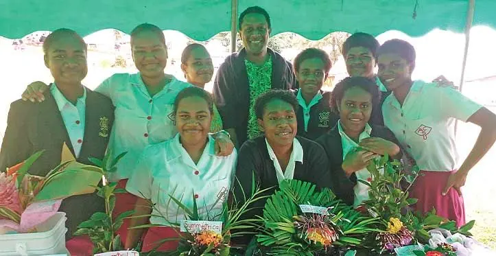Peniasi Vosabalavu with his agriculture students in fron of their flower arrangement booth. Photos: Ana Masere