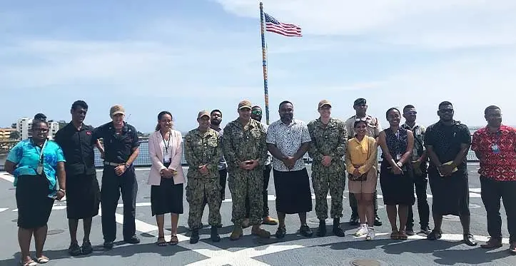 Crew members of the USS Pearl Harbor with members of the media