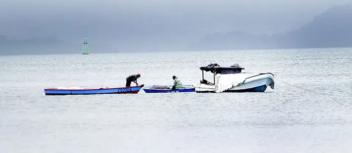 Men on their boats out at sea.