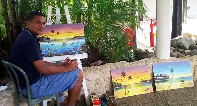 Timoci Sokoiwasa with his paintings at Shangri-La’s Fijian Resort.  Photo: Charles Chambers
