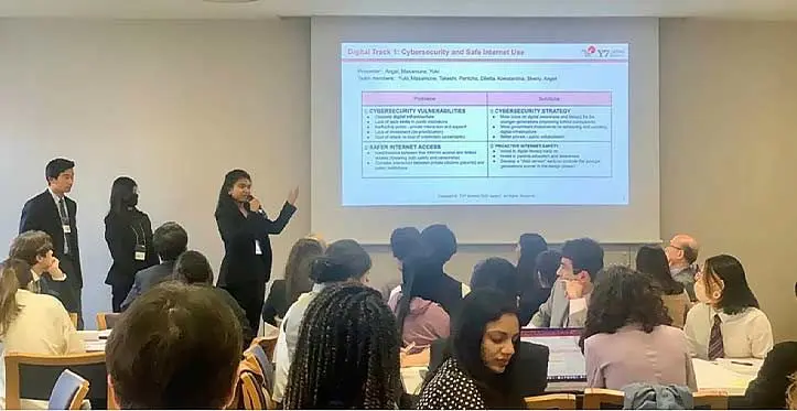 Angel Berlian with two Japanese high school students presenting on Cybersecurity and Safe Internet Use