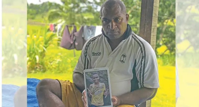 An emotional Sekove Waqadau Senior with a photo of his son and namesake at their home in Korovisilou on January 10, 2021.  Photo: Kelera Sovasiga