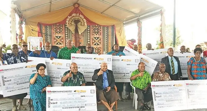 Prime Minister Voreqe Bainimarama with pine landowners who received their land security bonus payment at Tropik Wood, Drasa in Lautoka yesterday.  Photo: Charles Chamber 