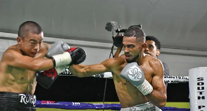 The late Ubayd Haider(right) lands a jab on China’s Runqi Zhou in the IBO Asia Pacific Super Featherweight title bout at Prince Charles Park in Nadi.  Photo: Waisea Nasokia