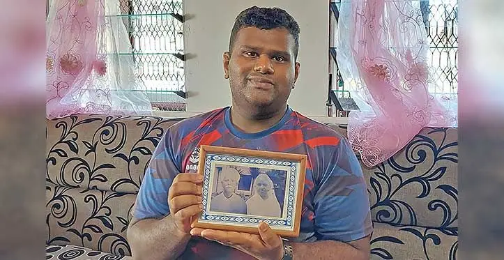 Adarsh Bhavish Dayal holds up a photo of his great grandparents (Left) Sampat and Ram Raj at his home in Tavarau, Ba. Photo: Salote Qalubau