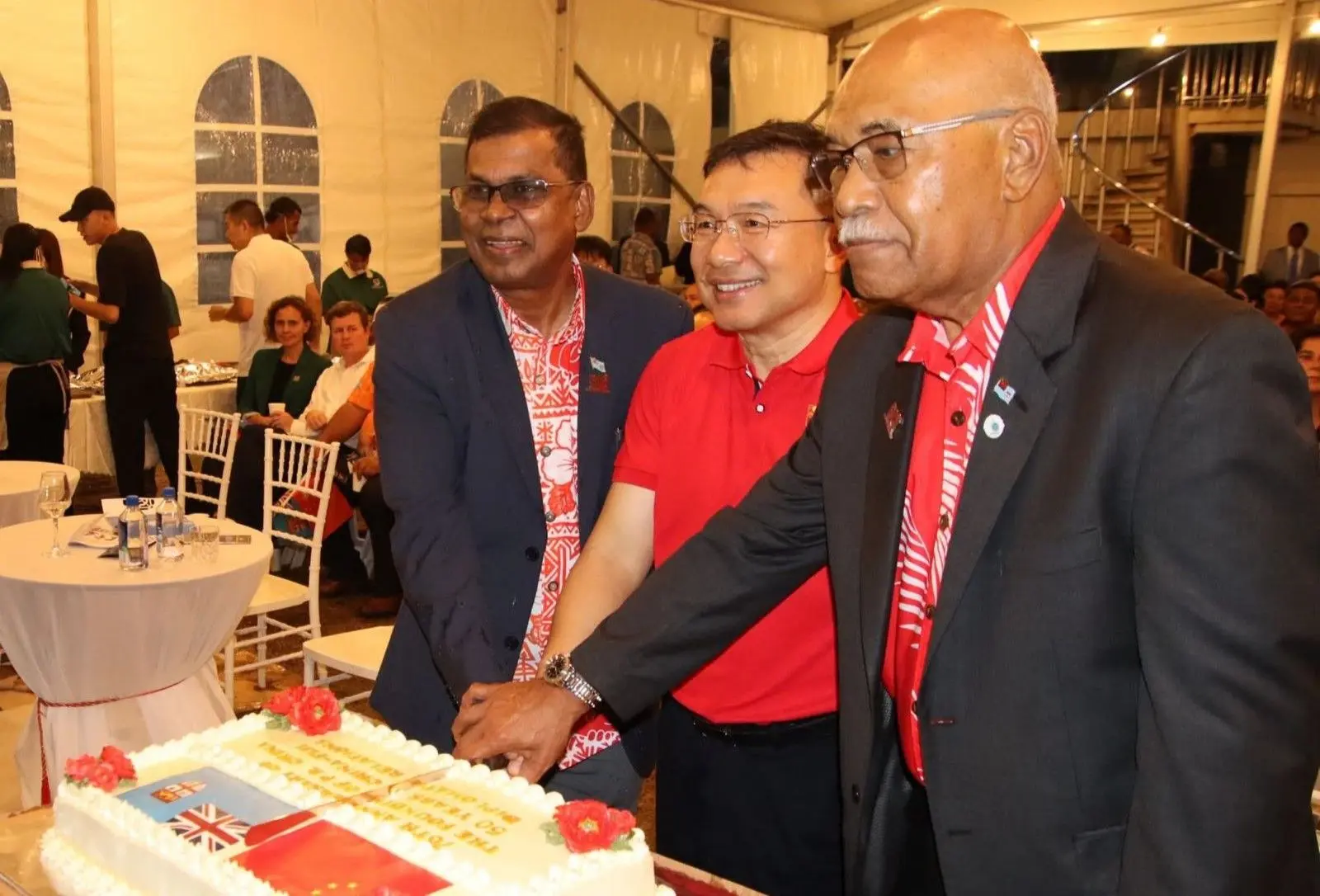 Acting Prime Minister Biman Prasad, Chinese Ambassador to Fiji Zhou Jian and Speaker of Parliament Filimone Jitoko cut the anniversary cake on September 27, 2025.
