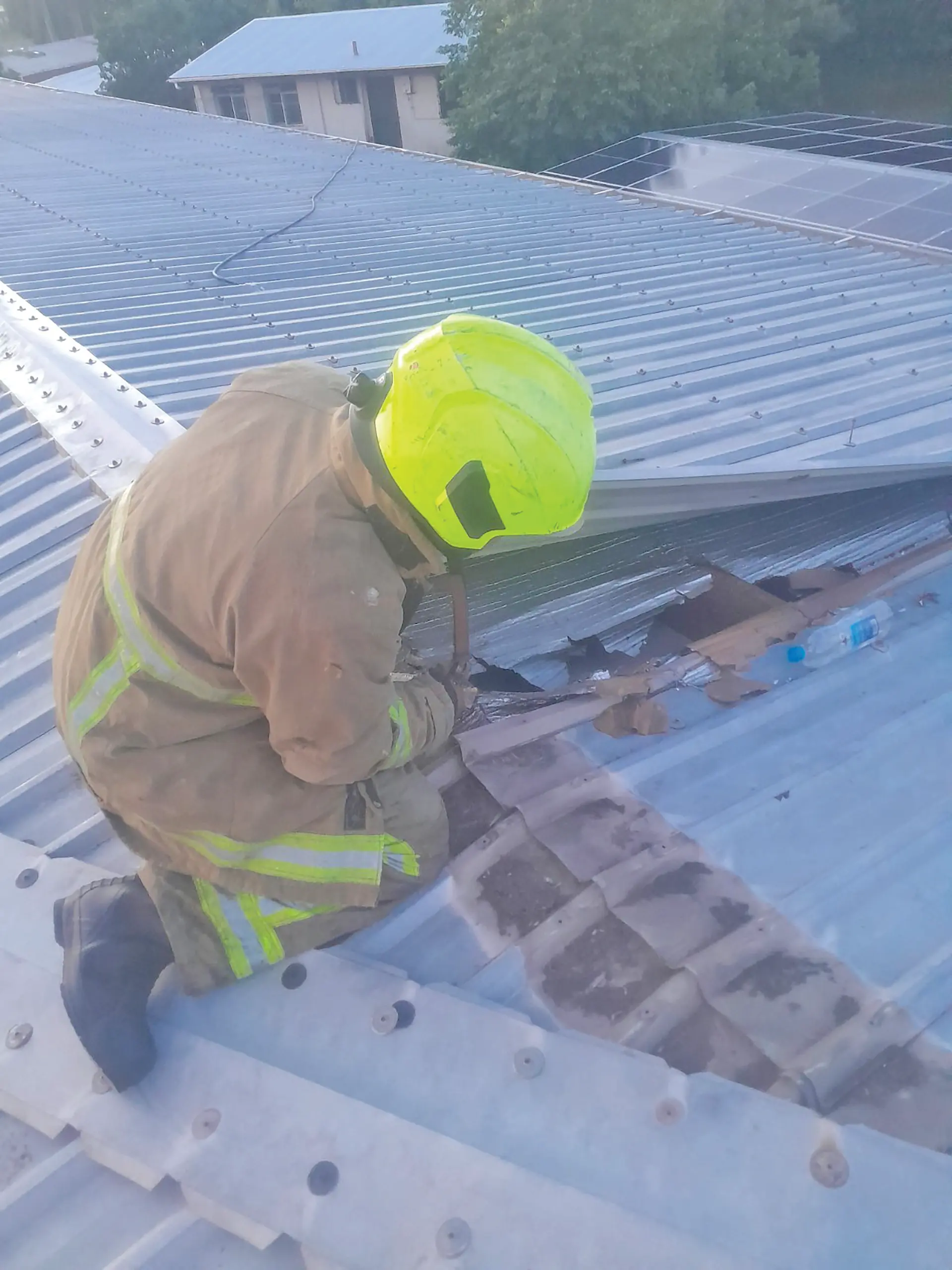 A firefighter works to cut through the roof at the Yat Sen school building in Suva on March 25, 2026