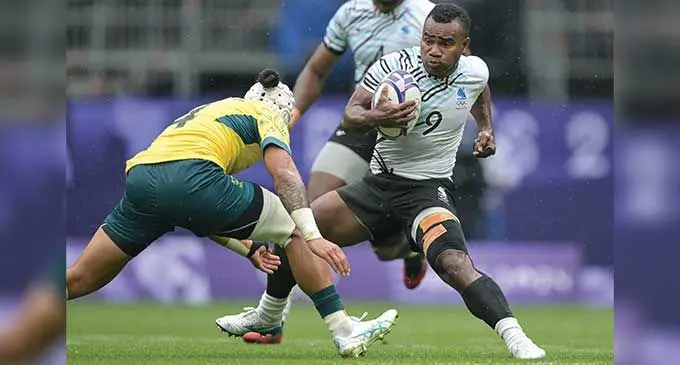 In the thick of things, Fiji men’s rugby sevens captain Jerry Tuwai on attack against Australia in the medal semifinal of the Paris Olympic Games at the Stade de France. Fiji won 31-7.  Photo: AFP 
