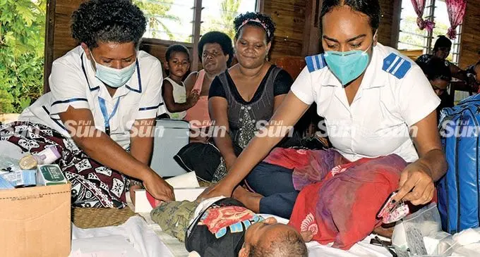 Staff nurses Loata Leku and Eka Somumu of the Makoi Health Centre examine one-year-old Sakeasi Bureira during an outreach programme at Muanikoso Village, Nasinu, on March 15, 2022.  Photo: Ronald Kumar