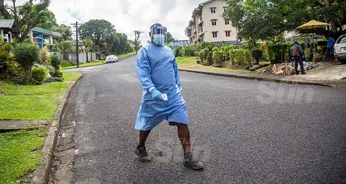 A Ministry of Health and Medical Services staff member during their contact tracing checks in Raiwai, Suva on May 7, 2021. Photo: Leon Lord.