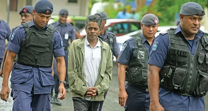 Kishore Kumar escorted by Police officers to the court house holding cell on November 27, 2020. Photo: Ronald Kumar