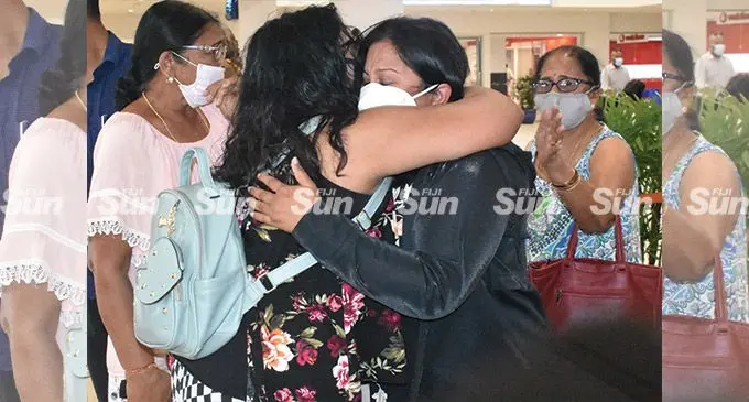 Rajneeta Devi (in black) meets her family at Nadi International Airport, as commercial fights recommenced between Nadi and Wellington. Photo: Mereleki Nai