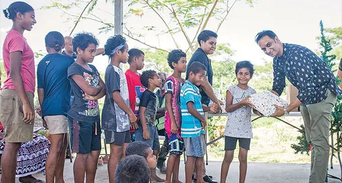 Amitesh Deo (first from right) presents Christmas Gifts to children of Vunato settlement in Lautoka. Photo: Pacific Recycling Foundation and Waste Recyclers Fiji Limited