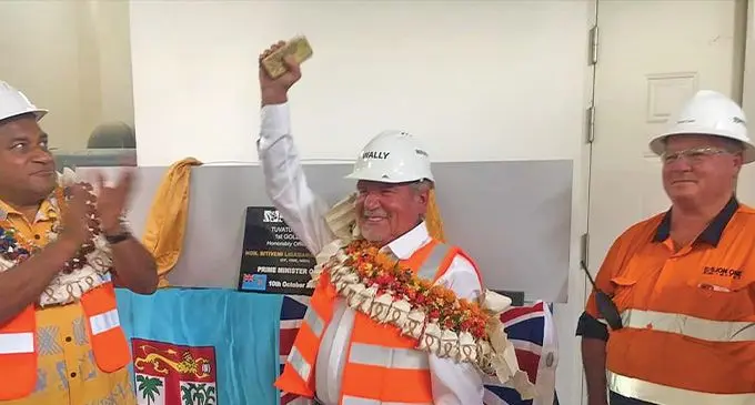 Acting Minister for Mineral Resources Maciu Katamotu (left) eyes the first gold bar produced by Lion One during its first gold pour on October 10, at Tuvatu. For Lion One founder and chief executive officer Walter Berukoff, it was history in the making after 17 years of ownership of the site. Photo: Lion One