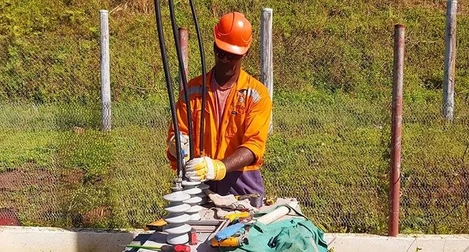 Working to restore power .... an EFL worker at Nabouwalu. Photo: Joe Raketekete